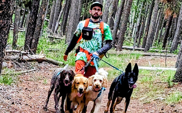 Two staff members posing beside Hike Doggie van