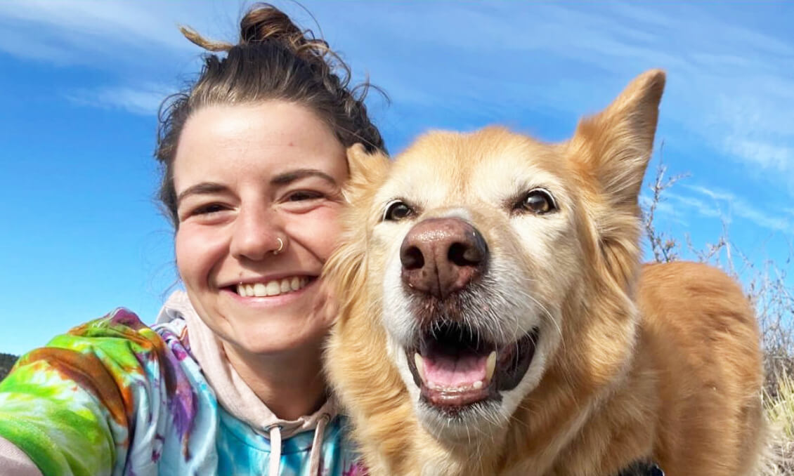 Woman smiling with golden retriever selfie, happy client moment
