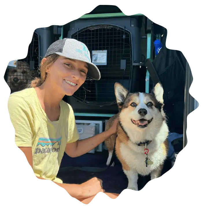 Handler smiling with husky beside Hike Doggie van, friendly dog pickup