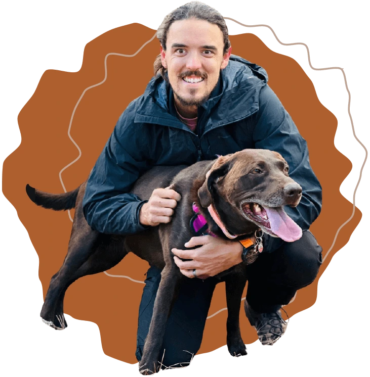 Man kneeling and hugging black bully, trusted handler bonding moment