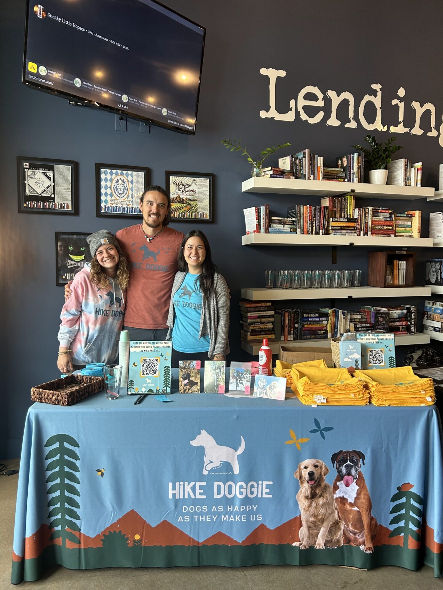 Hike Doggie booth at community event with staff and merchandise